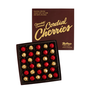 Milk and dark chocolate cordial cherries in box gold and red foil white background
